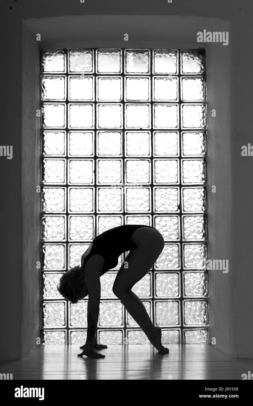 Woman`s silhouette with window on the background in black and white tones Stock Photo